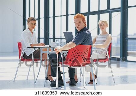 Business people working at desk View Large Photo Image Stock Photo - Business people working at desk. Fotosearch
