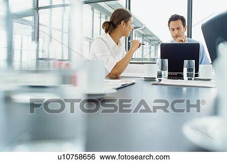 Business people working at desk View Large Photo Image Stock Photograph - Business people working at desk. Fotosearch