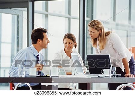 Business people working at desk View Large Photo Image Stock Photography - Business people working at desk. Fotosearch