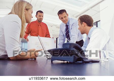 Business people working at desk together View Large Photo Image Stock Photo - Business people working at desk together. Fotosearch