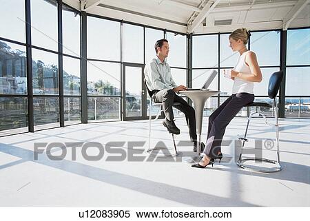 Stock Photography - Business people working at modern desk. Fotosearch