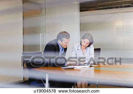 Stock Photo - Business people working in office. Fotosearch