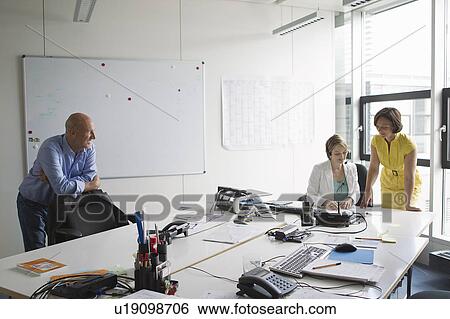 Stock Photograph - Business people working in office. Fotosearch