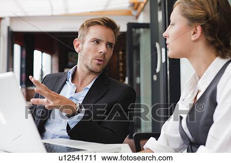 Stock Image - Business people working on laptop. Fotosearch