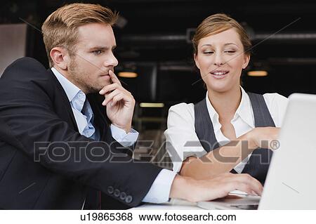Stock Photo - Business people working on laptop. Fotosearch