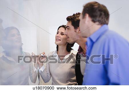 Business people writing on whiteboard View Large Photo Image Stock Image - Business people writing on whiteboard . Fotosearch