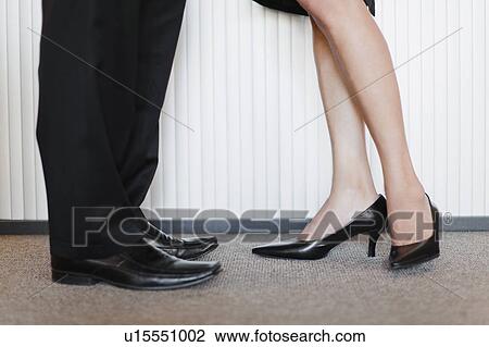 Stock Image - Business people’s legs and feet. Fotosearch