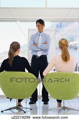 Businessman addressing colleagues View Large Photo Image Stock Photo - Businessman addressing colleagues. Fotosearch