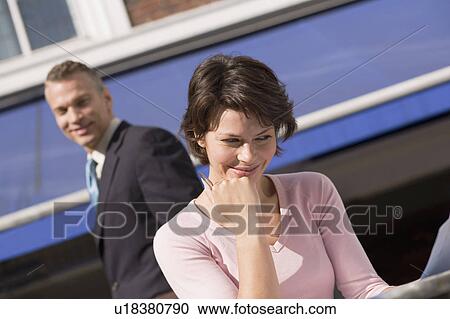 Businessman admiring female colleague View Large Photo Image Stock Image - Businessman admiring female colleague. Fotosearch