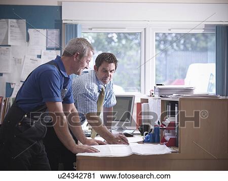 Businessman and worker in office View Large Photo Image Stock Image - Businessman and worker in office. Fotosearch