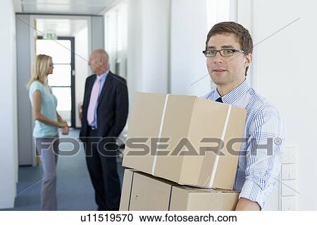 Businessman carrying cardboard boxes View Large Photo Image Stock Image - Businessman carrying cardboard boxes. Fotosearch