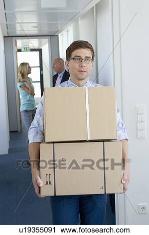 Businessman carrying cardboard boxes View Large Photo Image Stock Image - Businessman carrying cardboard boxes. Fotosearch