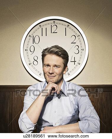 Businessman in front of clock View Large Photo Image Stock Image - Businessman in front of clock. Fotosearch