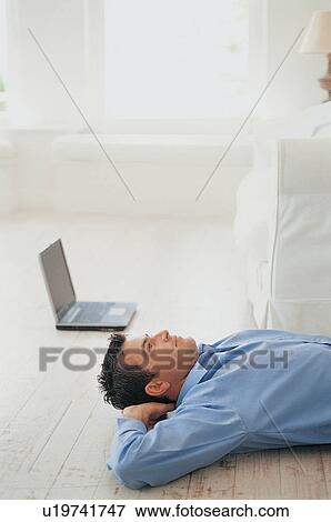 Businessman laying on floor View Large Photo Image Stock Photo - Businessman laying on floor. Fotosearch