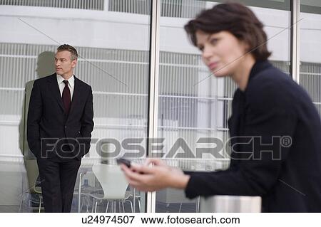 Businessman leaning on glass wall View Large Photo Image Stock Photo - Businessman leaning on glass wall. Fotosearch