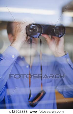 Businessman looking through binoculars View Large Photo Image Stock Image - Businessman looking through binoculars. Fotosearch
