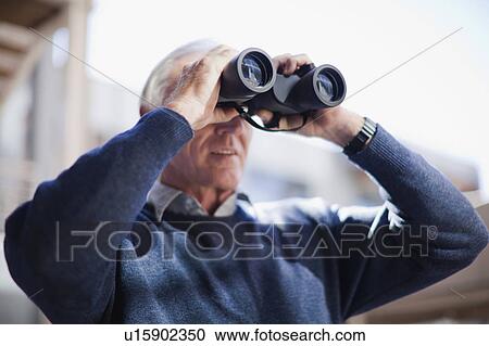 Businessman looking through binoculars View Large Photo Image Stock Image - Businessman looking through binoculars. Fotosearch