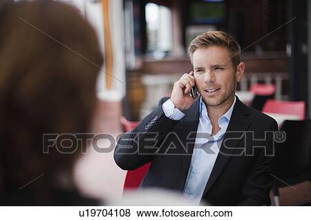 Businessman on cell phone at lunch View Large Photo Image Stock Photo - Businessman on cell phone at lunch. Fotosearch