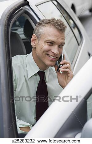 Businessman on cell phone in car View Large Photo Image Stock Image - Businessman on cell phone in car. Fotosearch