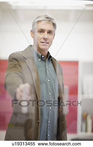 Stock Photography - Businessman opening office door. Fotosearch