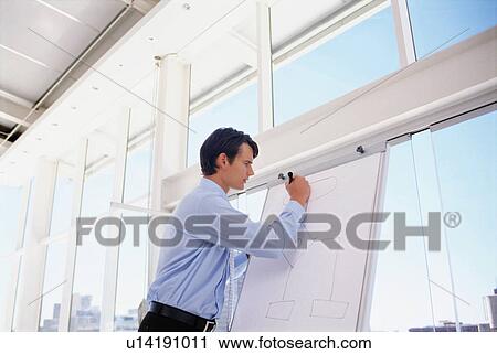 Businessman preparing lecture in office View Large Photo Image Stock Image - Businessman preparing lecture in office. Fotosearch