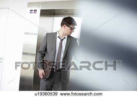 Businessman pressing elevator button View Large Photo Image Stock Photo - Businessman pressing elevator button. Fotosearch