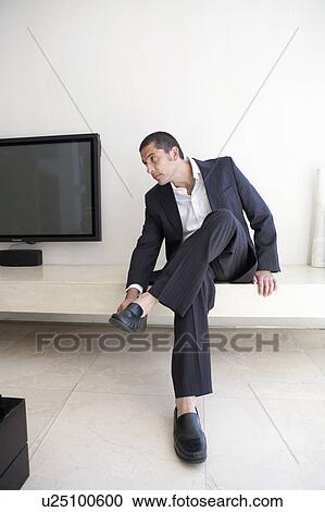 Businessman putting on shoes View Large Photo Image Stock Image - Businessman putting on shoes. Fotosearch