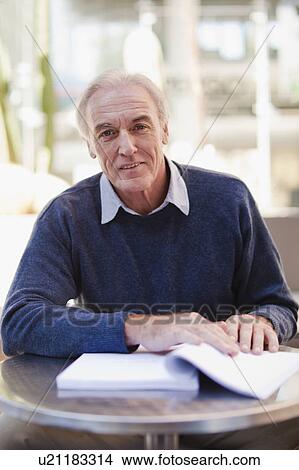 Businessman reading at cafe View Large Photo Image Picture - Businessman reading at cafe. Fotosearch