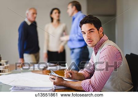 Businessman reading in meeting View Large Photo Image Stock Image - Businessman reading in meeting. Fotosearch