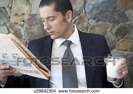 Businessman reading newspaper View Large Photo Image Picture - Businessman reading newspaper. Fotosearch