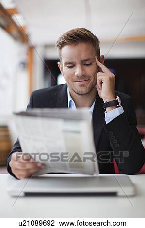 Businessman reading newspaper View Large Photo Image Stock Image - Businessman reading newspaper. Fotosearch