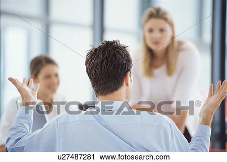 Businessman shrugging at desk View Large Photo Image Stock Image - Businessman shrugging at desk. Fotosearch