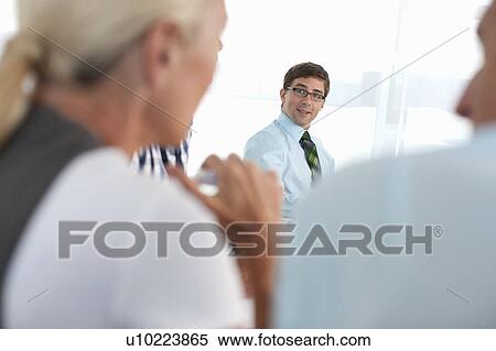 Stock Photography - Businessman sitting in conference. Fotosearch