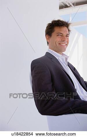 Businessman sitting in office chair View Large Photo Image Picture - Businessman sitting in office chair. Fotosearch