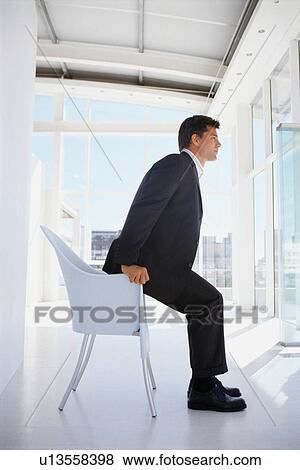 Businessman sitting in office chair View Large Photo Image Stock Photo - Businessman sitting in office chair. Fotosearch