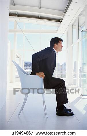 Businessman sitting in office chair View Large Photo Image Stock Photo - Businessman sitting in office chair. Fotosearch