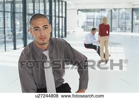 Businessman sitting in office View Large Photo Image Stock Photo - Businessman sitting in office. Fotosearch