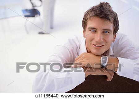 Businessman sitting on chair View Large Photo Image Stock Image - Businessman sitting on chair. Fotosearch