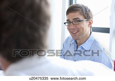 Businessman smiling in conference View Large Photo Image Stock Photography - Businessman smiling in conference. Fotosearch