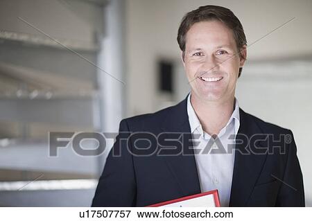 Stock Photo - Businessman smiling in office. Fotosearch