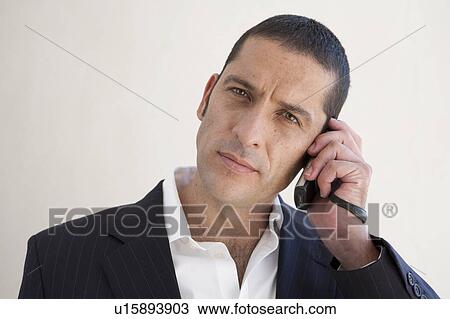 Businessman talking on cell phone View Large Photo Image Stock Image - Businessman talking on cell phone. Fotosearch