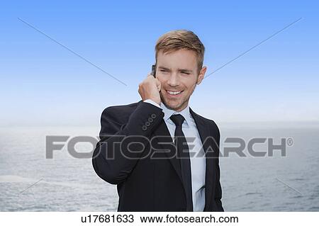 Businessman talking on cell phone View Large Photo Image Stock Image - Businessman talking on cell phone. Fotosearch