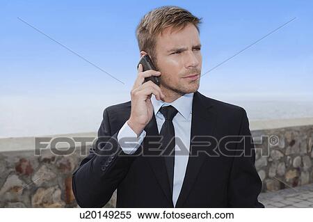 Businessman talking on cell phone View Large Photo Image Stock Photography - Businessman talking on cell phone. Fotosearch