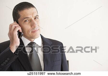 Stock Photo - Businessman talking on telephone. Fotosearch