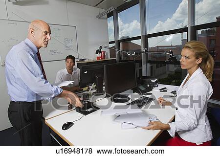 Businessman talking to colleagues View Large Photo Image Stock Photo - Businessman talking to colleagues. Fotosearch