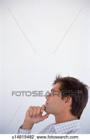 Businessman thinking with chin in hand View Large Photo Image Stock Image - Businessman thinking with chin in hand. Fotosearch