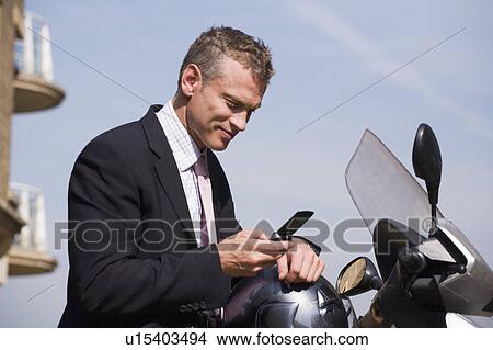 Businessman using cell phone View Large Photo Image Picture - Businessman using cell phone. Fotosearch