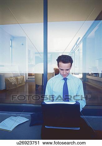 Stock Image - Businessman using laptop outdoors. Fotosearch