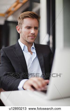 Stock Image - Businessman using laptop. Fotosearch