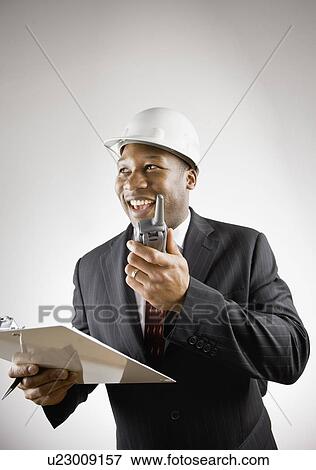 Businessman using walkie talkie View Large Photo Image Stock Photo - Businessman using walkie talkie. Fotosearch